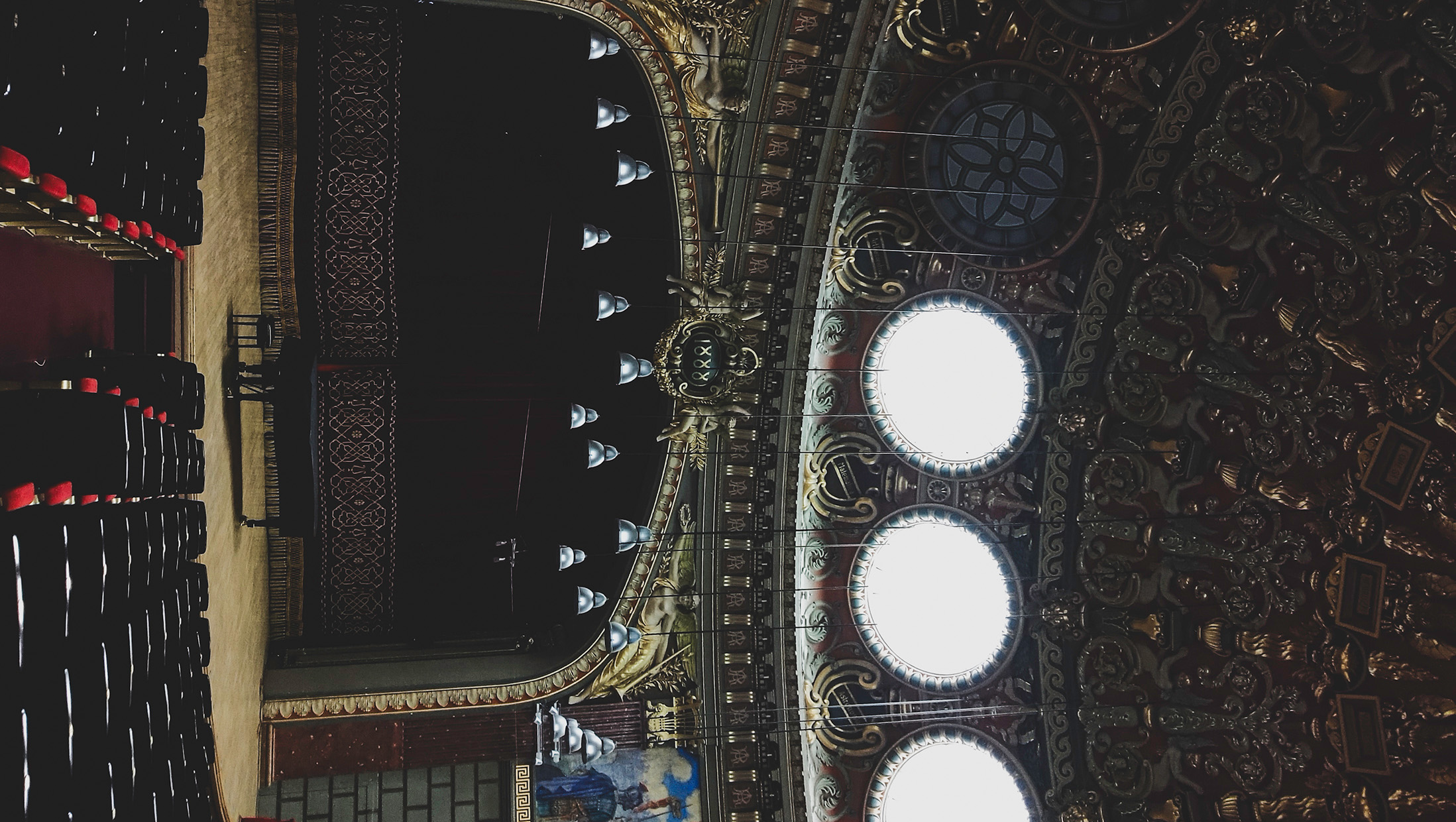 Ornate theater interior with rows of empty seats